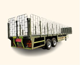 Large flatbed trailer with metal side rails and dual rear axles on a plain background.